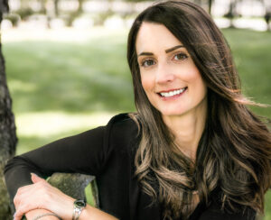 Smiling woman sitting on a bench.